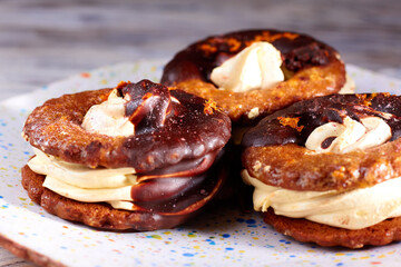 Close up of three homemade chocolate covered marshmallow crackers on plate