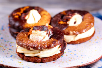 Close up of three homemade chocolate covered marshmallow crackers on plate