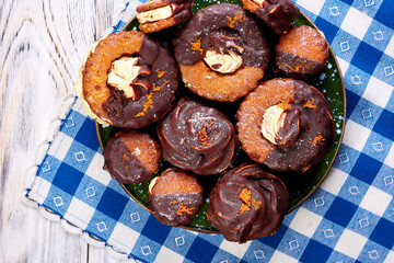 Close up of many marshmallow cookies on a plate on a blue and white napkin. Top view