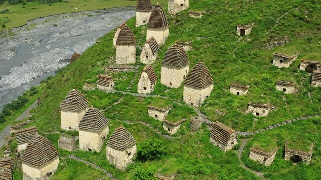 Aerial view of Dead Town Dargavs In North Ossetia. The ancient cemetery of the Alans. Many small stone mausoleums, 4k