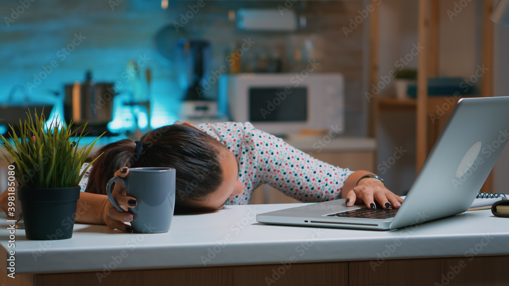 Poster businesswoman who worked until midnight on project felling asleep on desk working from home with han