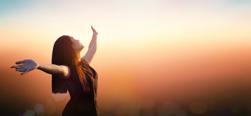 Worship God concept: Happy girl on blurred mountain sunrise background. Ai Yerweng, Bethong, Yala, Thailand, Asia