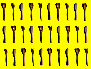 Wooden Cooking utensils on yellow background