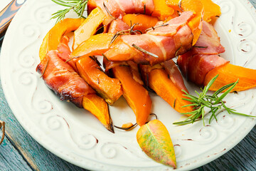 Baked pumpkin in bacon.