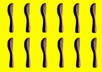 Wooden Cooking utensils on yellow background