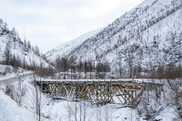 Wooden bridge, snowy mountains, gulag, Kolyma, the R504 Kolyma Highway, the Road of Bones, Yakutia, Sakha Republic, Russian North, Pole of cold