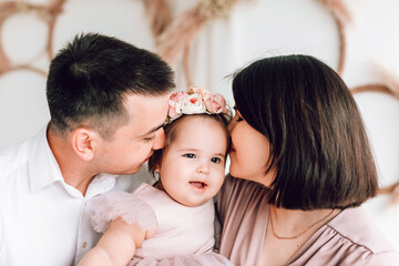 Happy strong family in a white light room