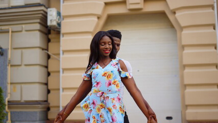 Girl and guy making dance elements in city. man and woman dancing on street