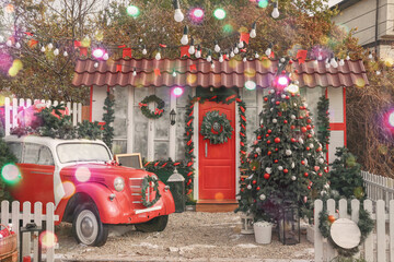 Car and fir tree near house decorated for Christmas