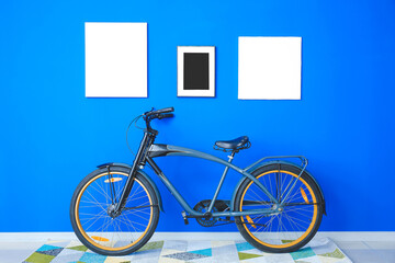 Interior of modern room with bicycle and blank photo frames