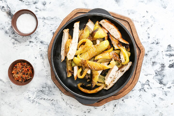Bowl with roasted pepper and spices on light background