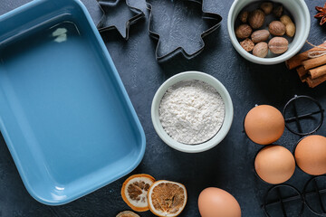 Ingredients for bakery and kitchen utensils on dark background
