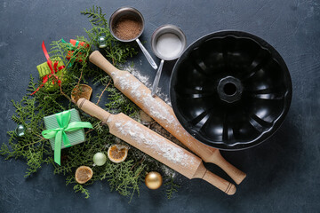 Ingredients for Christmas bakery and kitchen utensils on dark background