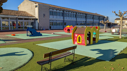 empty outdoors schoolyard school playground preschool building exterior with little house and bench - Powered by Adobe