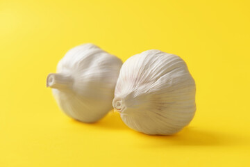 Obraz na płótnie Canvas Fresh garlic on color background. Erotic and female health care concept