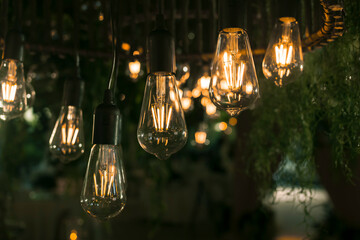 Beautiful warm incandescent led string light used as part of ceiling decor at a wedding reception. Shallow focus area. Background image.
