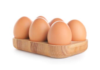 Wooden holder with chicken eggs on white background
