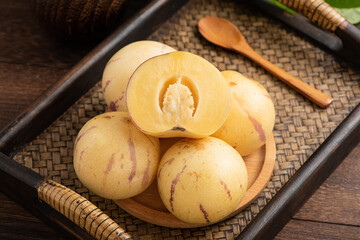 Fresh fruit ginseng fruit on the background of retro Chinese style tea plate