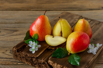 Ripe pears fruit. Harvested organic pear on cutting board on wooden table. Autumn harvest.