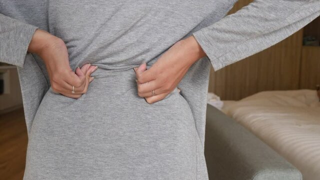 Woman hands holding lower back and suffering from Kidneys pain,Lumbar disc herniation,Low back pain lumbar backache