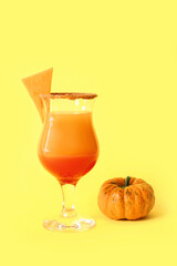 Glass of tasty pumpkin pie martini on color background