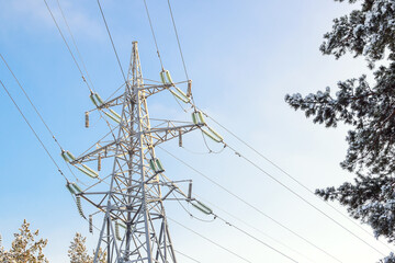Metal support illuminated by bright sun. Power transmission tower against the sky. Electric power for transfer power by electrical grids. High voltage electric.