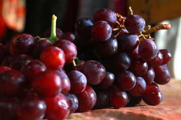 Healthy fruits Red wine grapes background/ dark grapes/ blue grapes/wine grapes,Red wine grapes background/dark grapes,blue grapes,Red Grape in a supermarket local market bunch of grapes ready to eat
