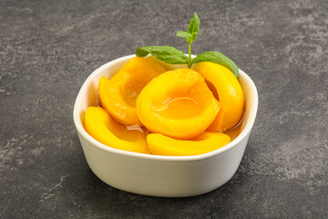 Sweet ripe canned peaches with mint