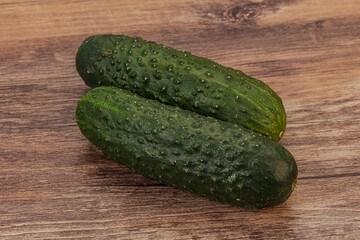 Green fresh cucumbers over background