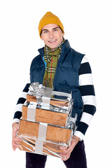 A handsome adult man in a striped jumper is holding several gifts in silver packaging and smiling. Isolate on white. New Year advertising concept. 