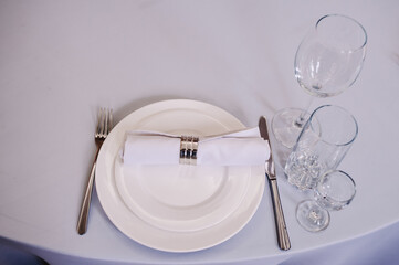 Serving, setting table. Plate and silverware cutlery linen white napkin. Wedding table decoration....