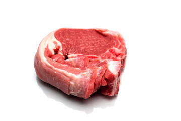 One raw lamb chop on a white isolated surface. Meat industry product