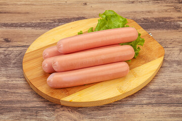 Tasty meat sausages over board