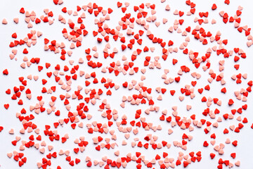 sprinkles background, sugar sprinkle red hearts, decoration for cake and bakery. Top view, flat lay. Valentines holiday