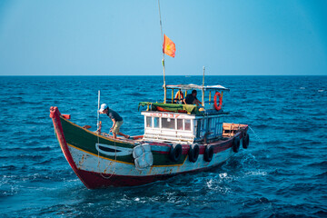 fishing boat at sea with blue sky background 