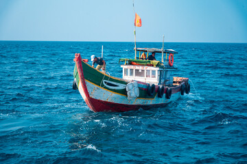 fishing boat at sea with blue sky background 