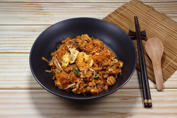 Pad Thai, Spicy Fried and stirred noodle with traditional sauce and mixed with egg and shrimp on the plate. Popular menu in Thailand street food.