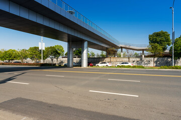 Fototapeta na wymiar Concrete structure and asphalt road space under the overpass in the city