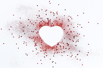 Red confetti glitter in shape of heart on white festive background, copy space, valentines day...