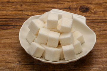 Refined white sugar cubs in the bowl