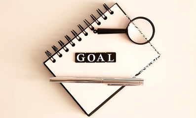 GOALS Business Words on notepad with pen and magnifier