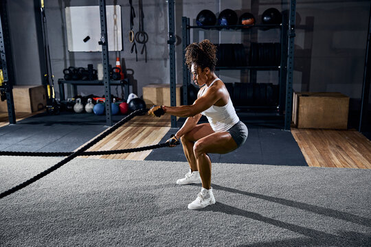 Athlete using the battle ropes during the training session