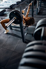 Female athlete lying on her back during the bench press