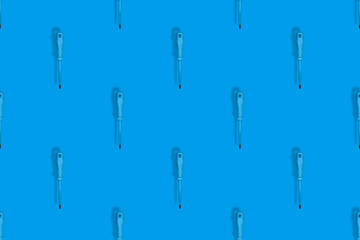 Rubberized metal screwdriver. Screwdriver seamless pattern. Background on the theme of tools.