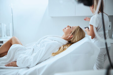 Relaxed woman before a cosmetic procedure in a beauty clinic