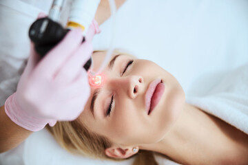 Young Caucasian woman being treated for forehead wrinkles