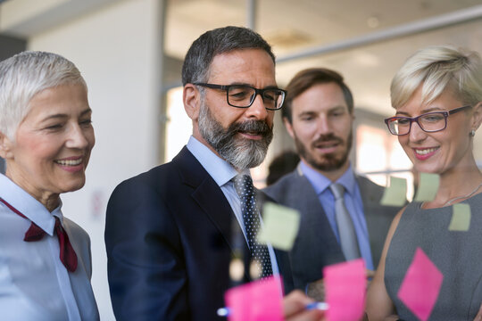 Happy success business people working, brainstoming together in office on meeting