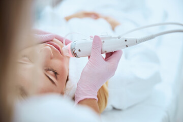 Woman client undergoing a professional skin rejuvenation treatment