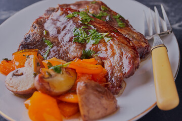 Lamb chops with mushrooms and peppers.