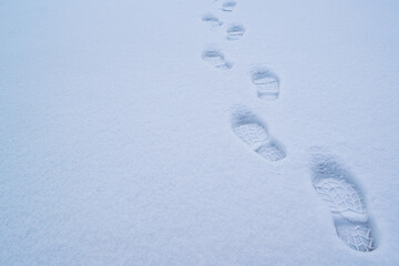 Footsteps on the snow-white snow at dusk.